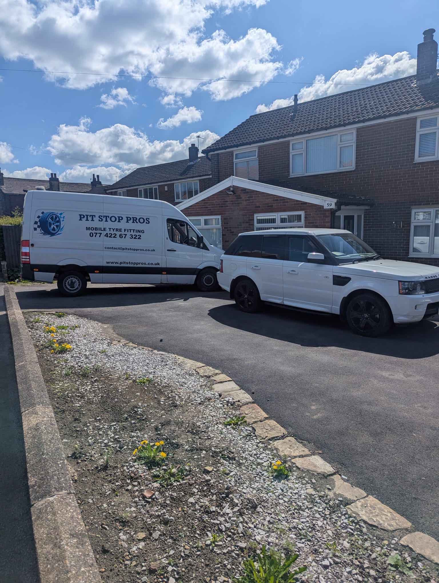 Pit Stop Pros van servicing a premium SUV on a residential driveway